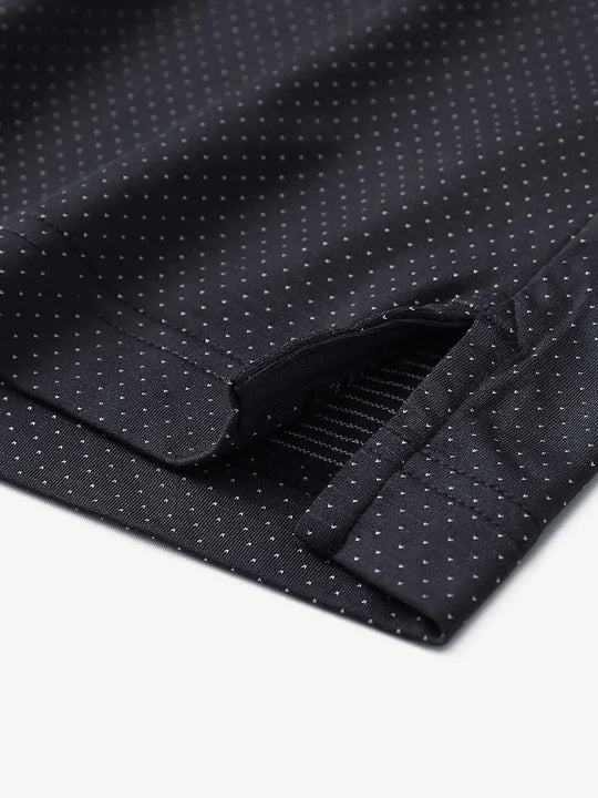 Detail of side slit hem on BLACK 4 Way Stretch Jacquard Polo — clean stitching and stretch finish