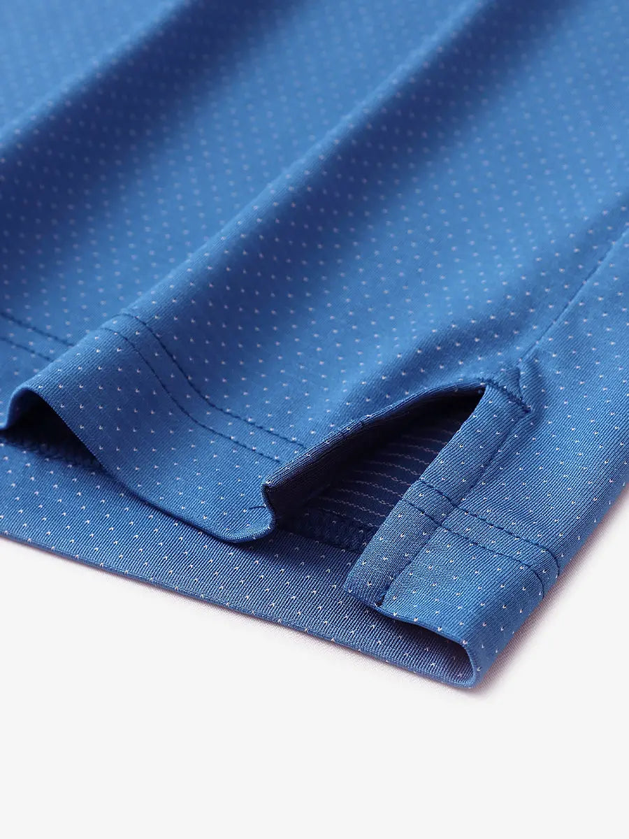 Detail of side slit hem on BLUE 4 Way Stretch Jacquard Polo — clean stitching and stretch finish