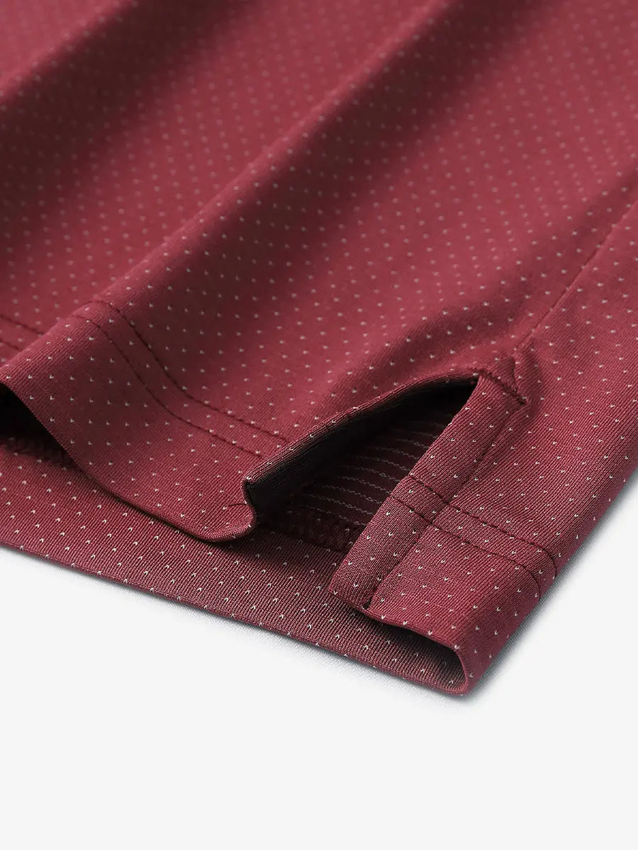 Detail of side slit hem on WINE 4 Way Stretch Jacquard Polo — clean stitching and stretch finish