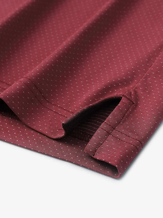 Detail of side slit hem on WINE 4 Way Stretch Jacquard Polo — clean stitching and stretch finish