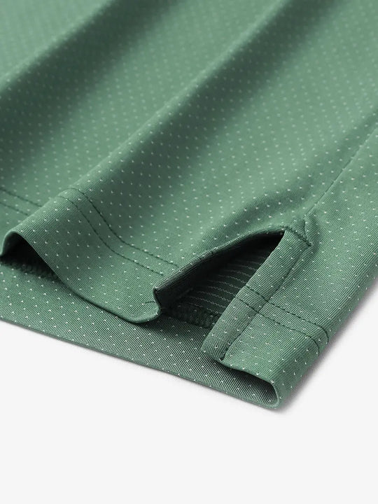 Detail of side slit hem on BERYL GREEN 4 Way Stretch Jacquard Polo — clean stitching and stretch finish