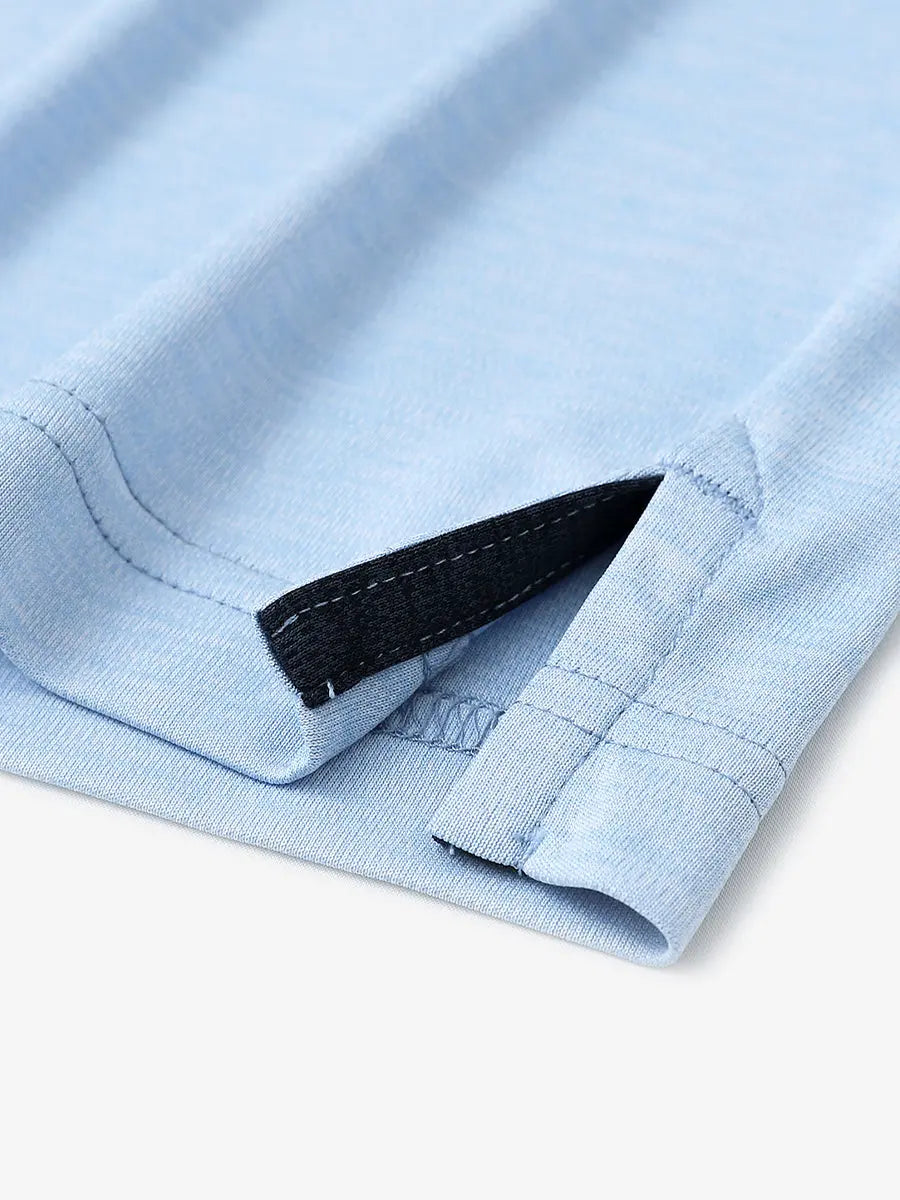 Close-up of hem opening on Modern Fit Melange Polo in LIGHT BLUE HEATHER, highlighting quality stitching.