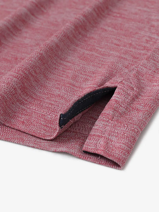 Close-up of hem opening on Modern Fit Melange Polo in DUSTY ROSE HEATHER, highlighting quality stitching.