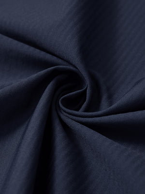 Close-up fabric detail of lightweight water-resistant outerwear jacket, smooth navy texture