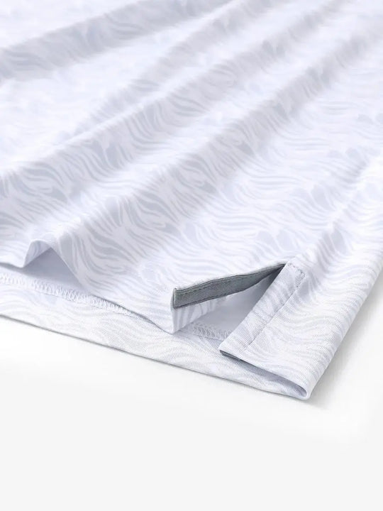 Hem slit detail of MAELREG Performance Jersey Print Polo in White Grey Sea Wave – comfort & movement
