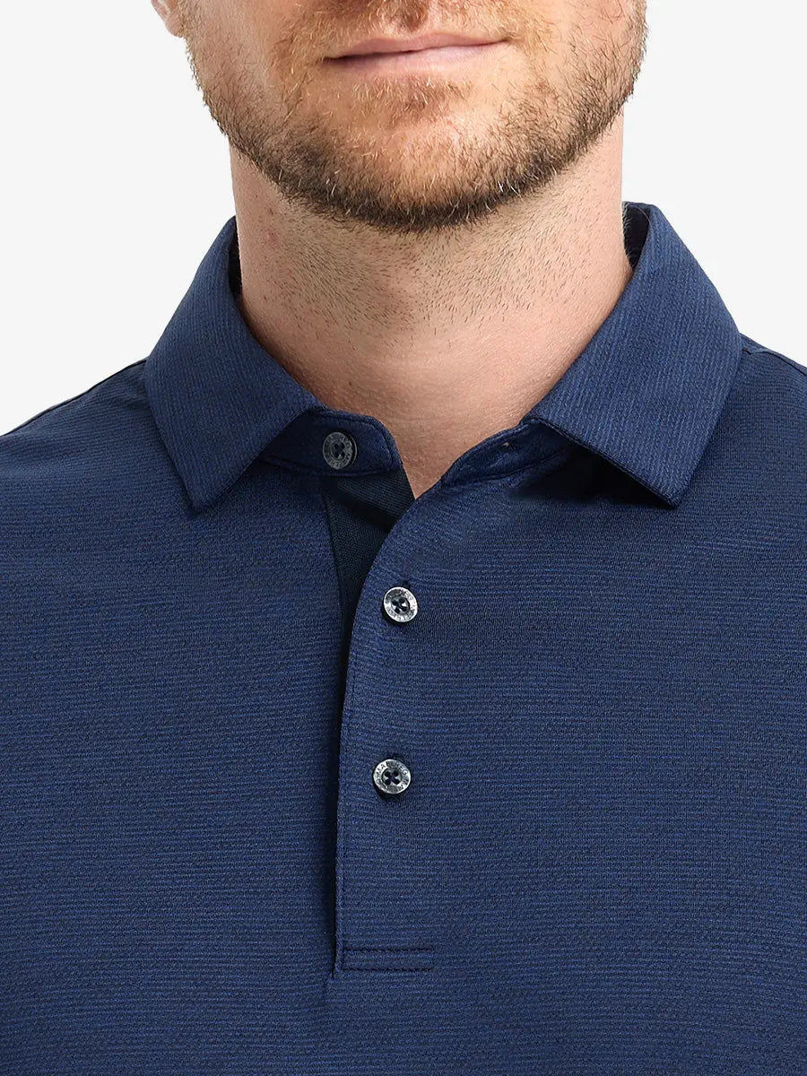 Model front view from nose to chest in DARK BLUE HEATHER Ventilated Heather Jacquard Polo