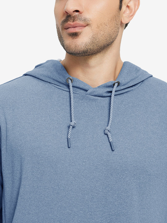 Close-up from nose to chest, showing soft heather texture and collar detail of the colony blue melange hoodie.