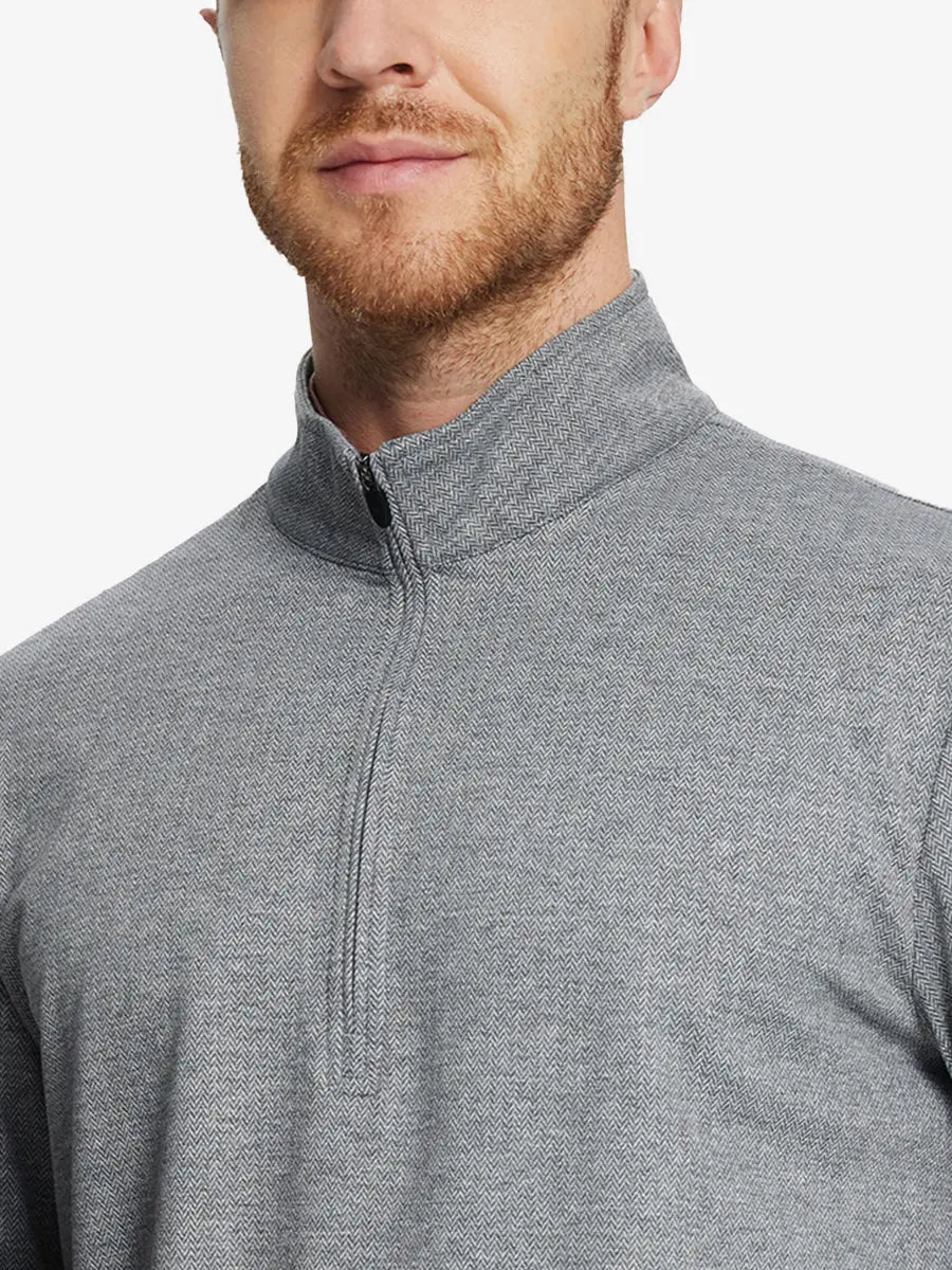 Front half-body view from nose down of model wearing SMOKY GRAY HERRINGBONE Premium Jacquard Quarter Zip Pullover.								
