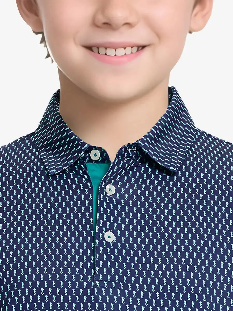 Close-up front view from nose to chest of boy wearing GREEN SEAHORSE Performance Print Boys Golf Polo