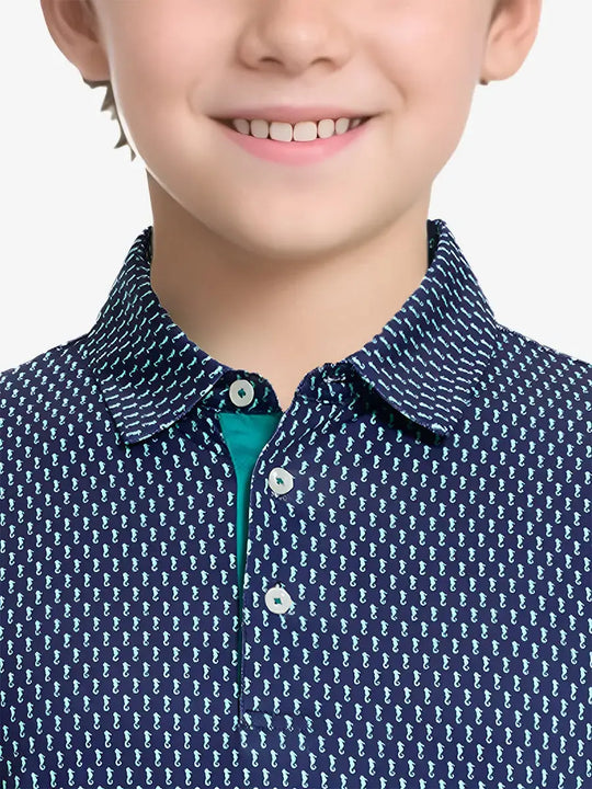 Close-up front view from nose to chest of boy wearing GREEN SEAHORSE Performance Print Boys Golf Polo