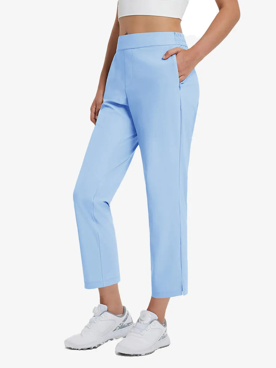 Front lower-body view of model with right hand in pocket wearing LIGHT BLUE Women's 7/8 Ankle Golf Track Pants.