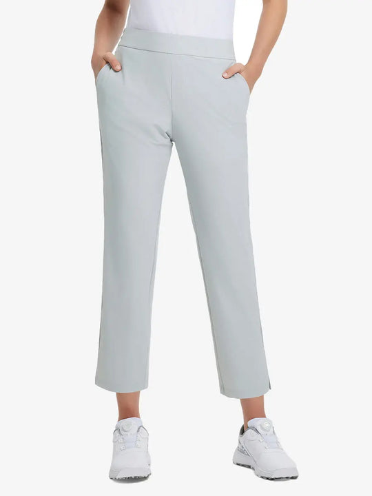 Front lower-body view of model with right hand in pocket wearing GLACIER GREY Women's 7/8 Ankle Golf Track Pants.