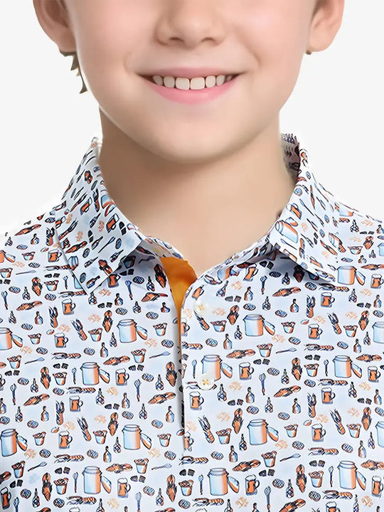 Close-up front view from nose to chest of boy wearing WHITE ORANGE PICNIC Performance Print Boys Golf Polo