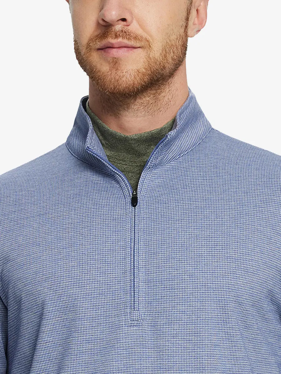 Front half-body view from nose down of model wearing BLUE HOUNDSTOOTH Premium Jacquard Quarter Zip Pullover.								
