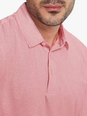 Front half-body view from nose to chest of model wearing PINK HEATHER Premium Stretch Heather Polo.