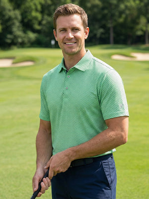 Model in green navy dot performance jersey print polo holding a golf club outdoors, half-body shots.
