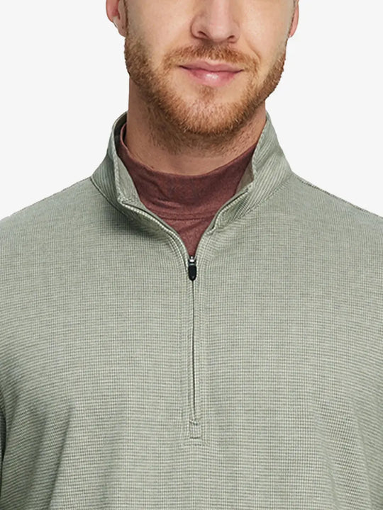 Front half-body view from nose down of model wearing SAGE GREEN HOUNDSTOOTH Premium Jacquard Quarter Zip Pullover.								
