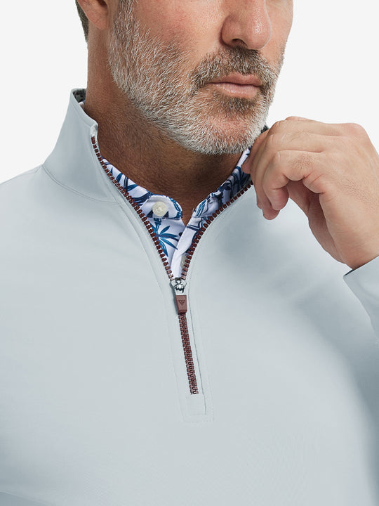 Close-up from nose to chest, showing collar and zipper detail of the misty grey golf pullover.