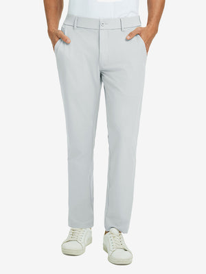 Front lower body view of model with hand in pocket, wearing quick dry casual dress pants in glacier grey.
