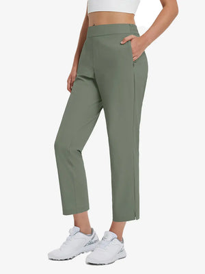 Front lower-body view of model with right hand in pocket wearing OLIVE GREEN Women's 7/8 Ankle Golf Track Pants.