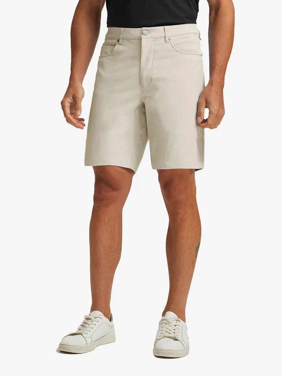 LIGHT KHAKI 4-way Stretch Performance Solid Shorts, golfer front lower body with club, 9 Inch view