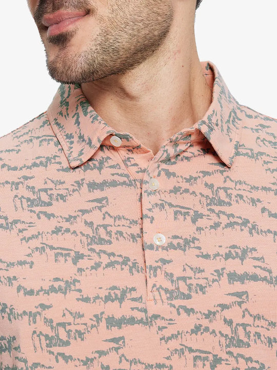 Front half-body view from nose to chest of model wearing LIGHT ORANGE MASSIF Popular Heather Print Polo