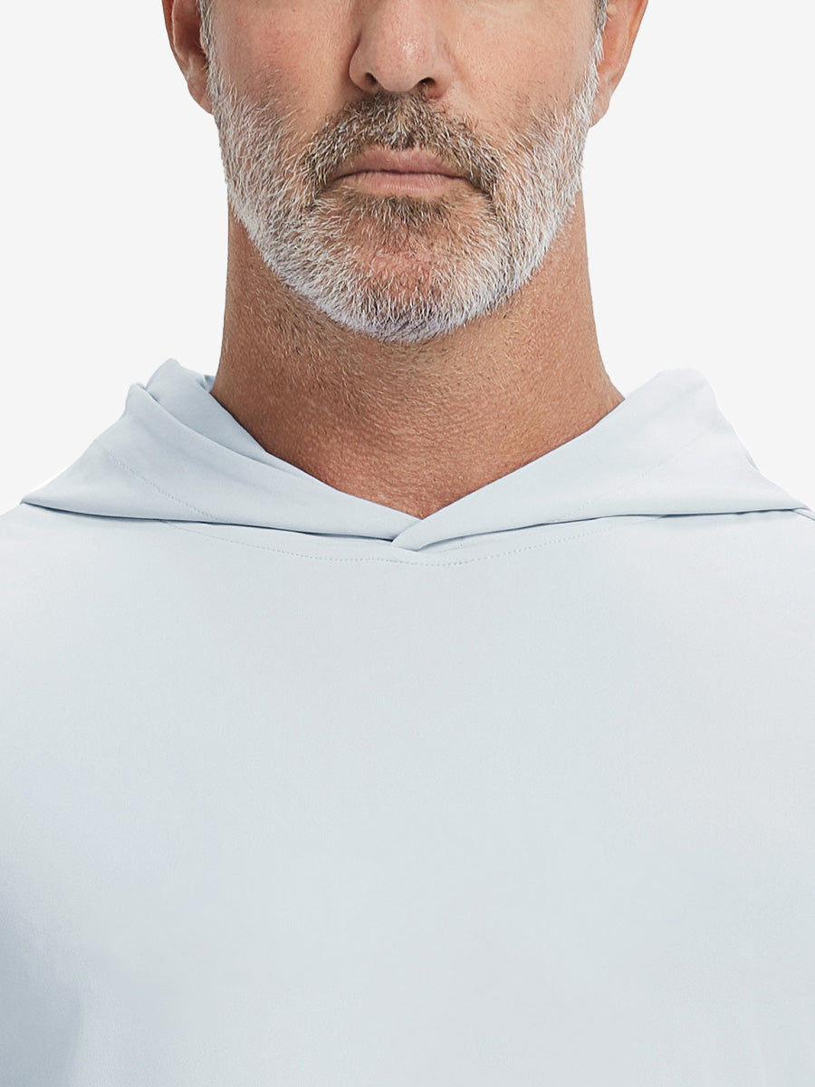 Close-up from nose to chest, showing soft collar texture and stitching detail of the misty grey hoodie.