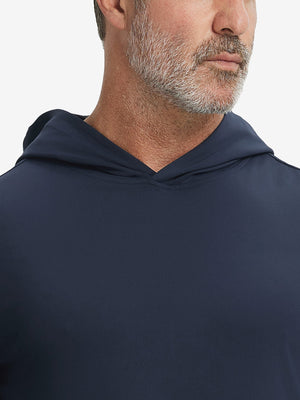 Close-up from nose to chest, showing soft collar texture and stitching detail of the navy hoodie.