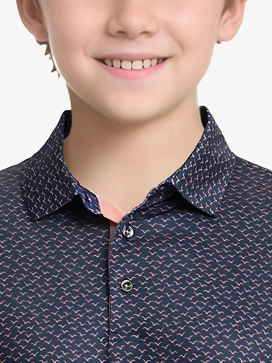 Close-up front view from nose to chest of boy wearing NAVY PINK SEAGULL Performance Print Boys Golf Polo