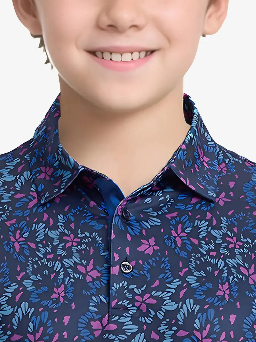 Close-up front view from nose to chest of boy wearing NAVY COLORFUL FLOWER Performance Print Boys Golf Polo