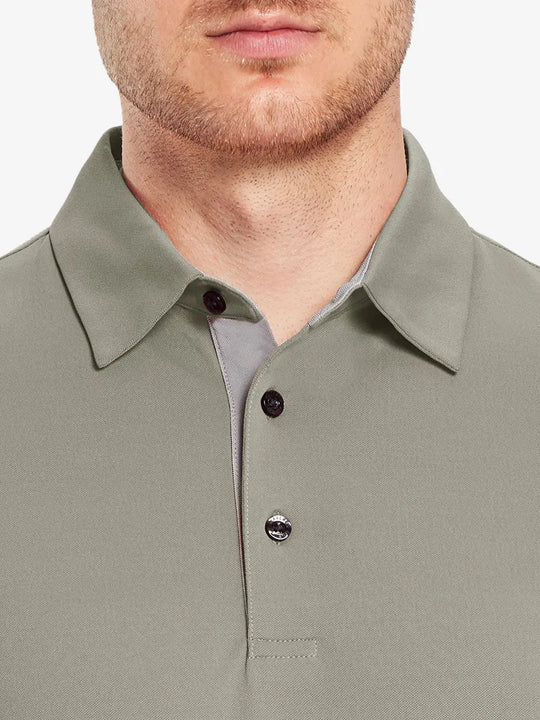 Model wearing the dark khaki long sleeve pique polo, emphasizing its stylish and comfortable design.