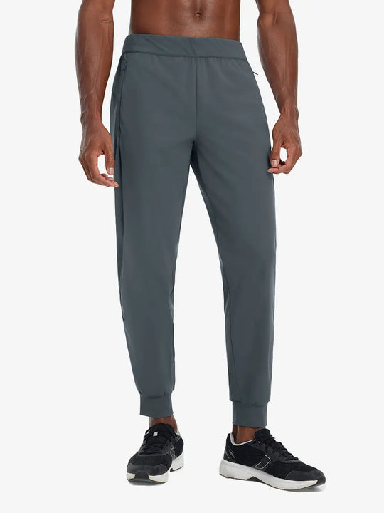 Front lower body view of model wearing DARK GREY Performance Tapered Sports Joggers