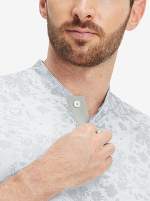 Close-up: nose to chest in grey splatter stretch printed collarless henley golf shirts