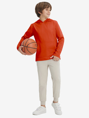 Full-body view of model holding basketball, wearing youth long sleeve hoodied with kangaroo pocket in orange.