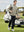 Texture heather fleece lined 1/4 zip pullover, model in dust beige carrying a golf bag full body view
