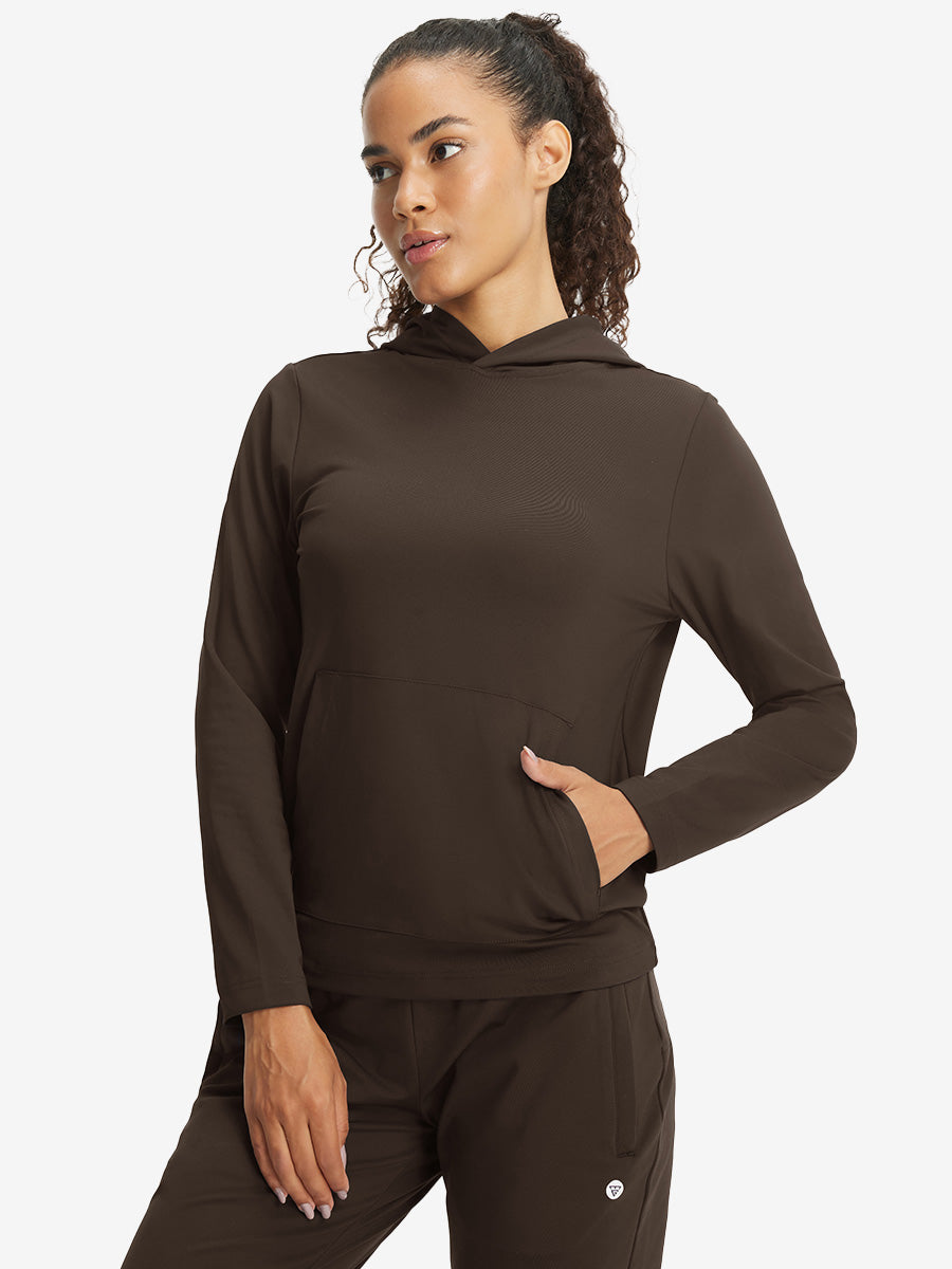 Model with one hand in side pocket wearing women's lightweight hoodies pullover in coffee brown.