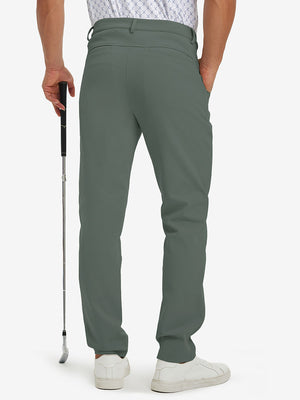 Back lower-body view of lightweight moisture wicking dress pants, model with golf club in slate green.
