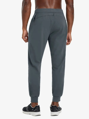 Back lower body view of model wearing DARK GREY Performance Tapered Sports Joggers