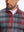 Upper front collar detail of full print lightweight quarter zip pullover, smooth zip and redblack check accent