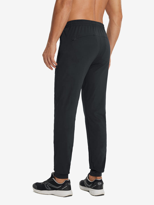 Back lower-body view showing lightweight traning track pants on model in black.