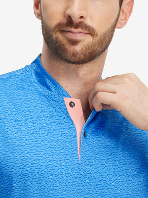 Close-up: nose to chest in blue wave dolphin stretch printed collarless henley golf shirts