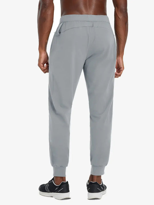 Back lower body view of model wearing LIGHT GREY Performance Tapered Sports Joggers