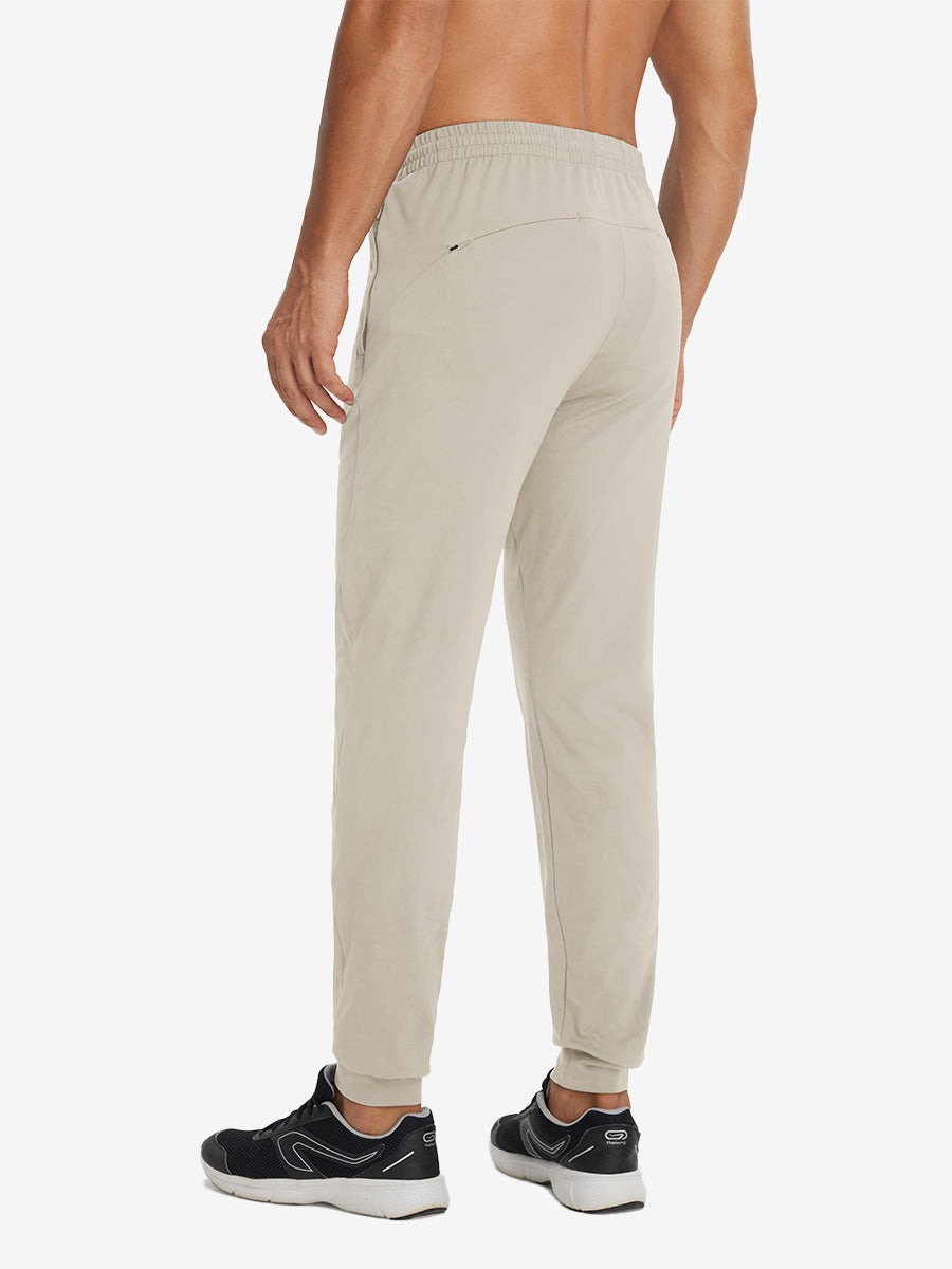 Back lower-body view showing lightweight traning track pants on model in khaki.