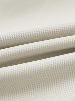Fabric close-up of lightweight moisture wicking dress pants, showing texture and finish in light khaki.