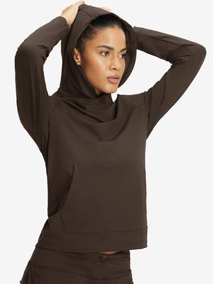 Model holding hoodie cap with both hands, wearing women's lightweight hoodies pullover in coffee brown.