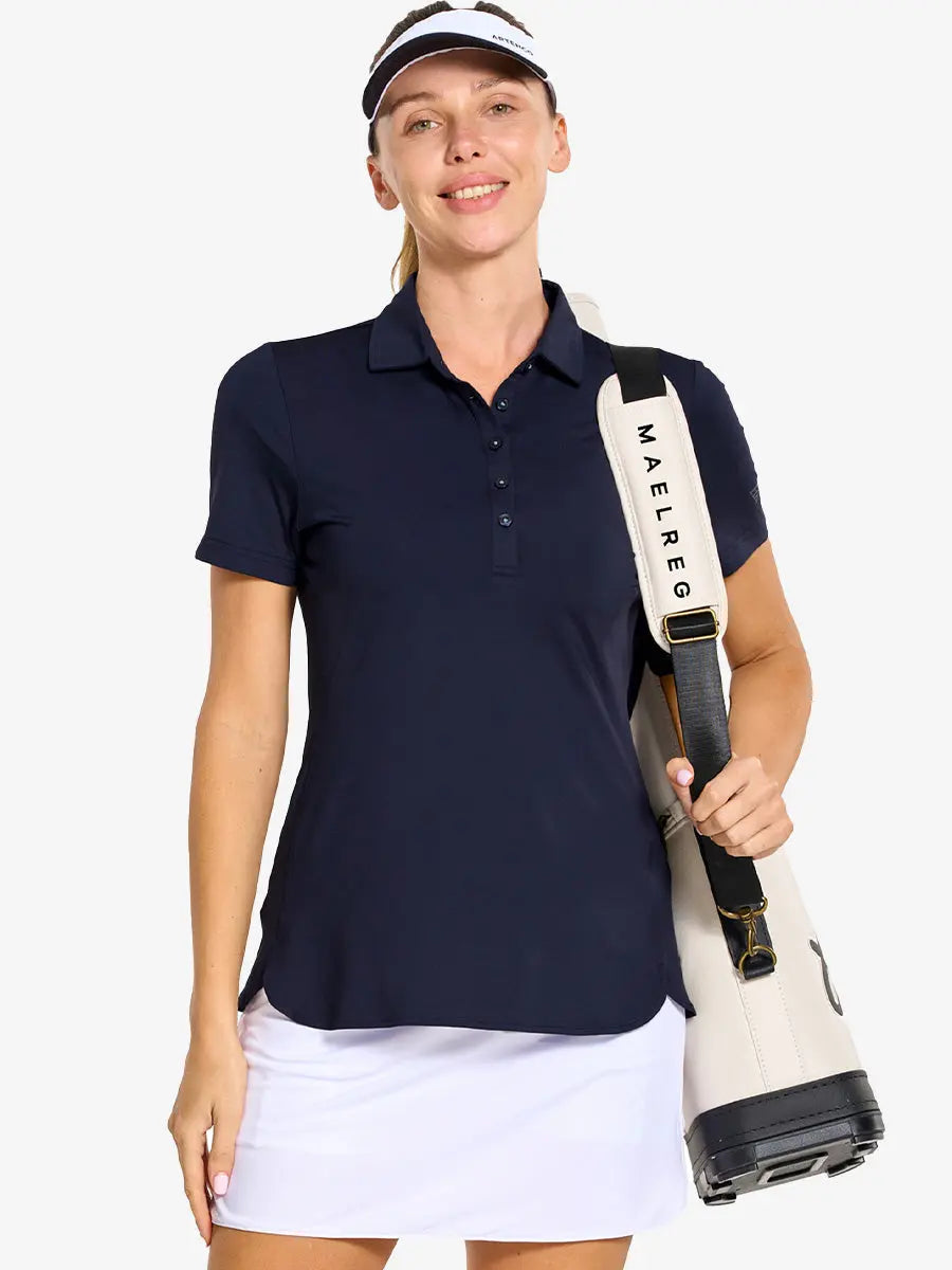 Front half-body of model in NAVY Women's Performance Solid Polo with golf bag