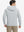 Back view of model wearing texture solid hoodies pullover showing fit and hood detail, light grey heather.