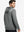 Back upper body view of the grey melange classic heather hoodie, model turns head slightly with ease.