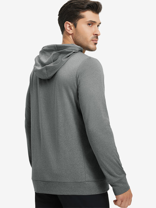 Back upper body view of the grey melange classic heather hoodie, model turns head slightly with ease.