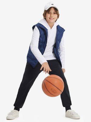 Full-body shot of model wearing black fleece stretch water resistant boys joggers while playing basketball.